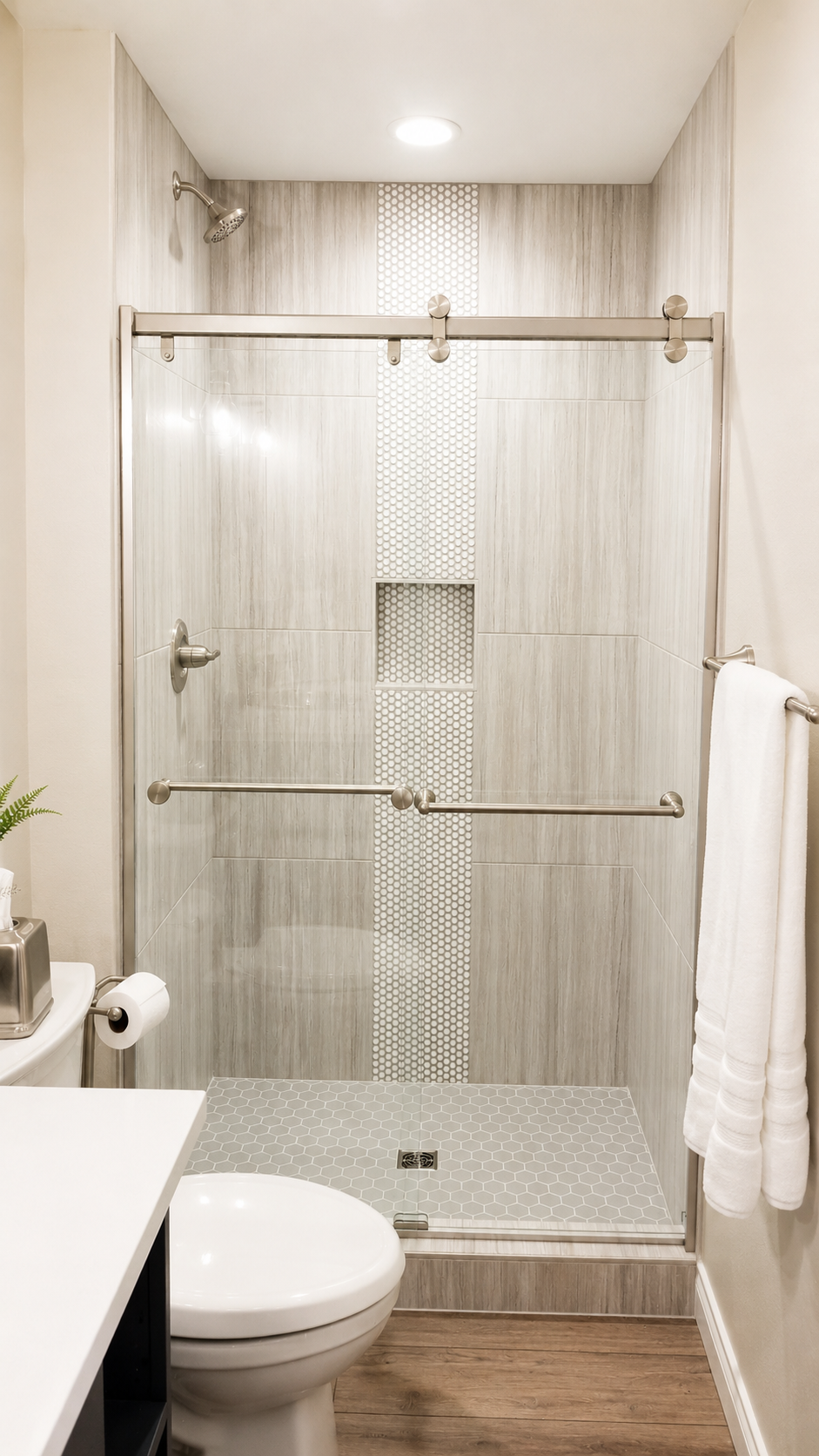 Finished basement bathroom featuring a tile surround, glass enclosure, and modern fixtures. Shows the type of finishes typical in a mid-range guest suite bathroom.