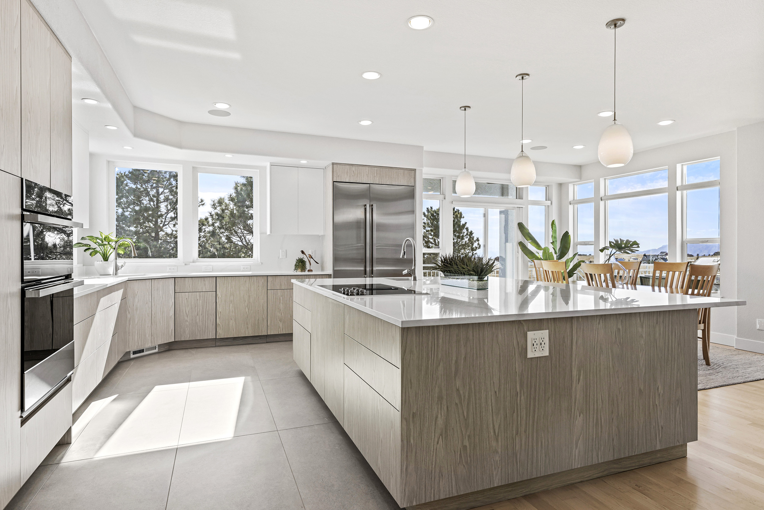 Modern kitchen remodel by Alpine Contracting. Double oven, cooktop, large granite island countertop, custom cabinets.