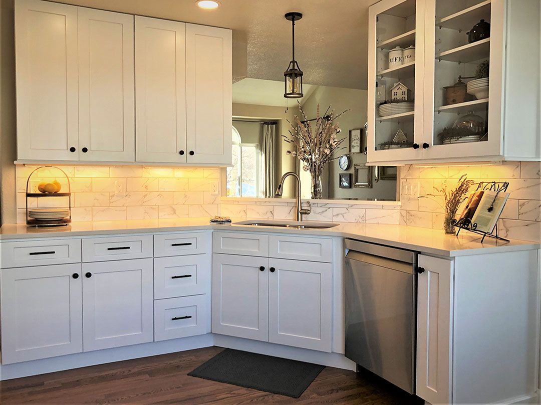 Kitchen remodel with new cabinets, sink, and faucet.