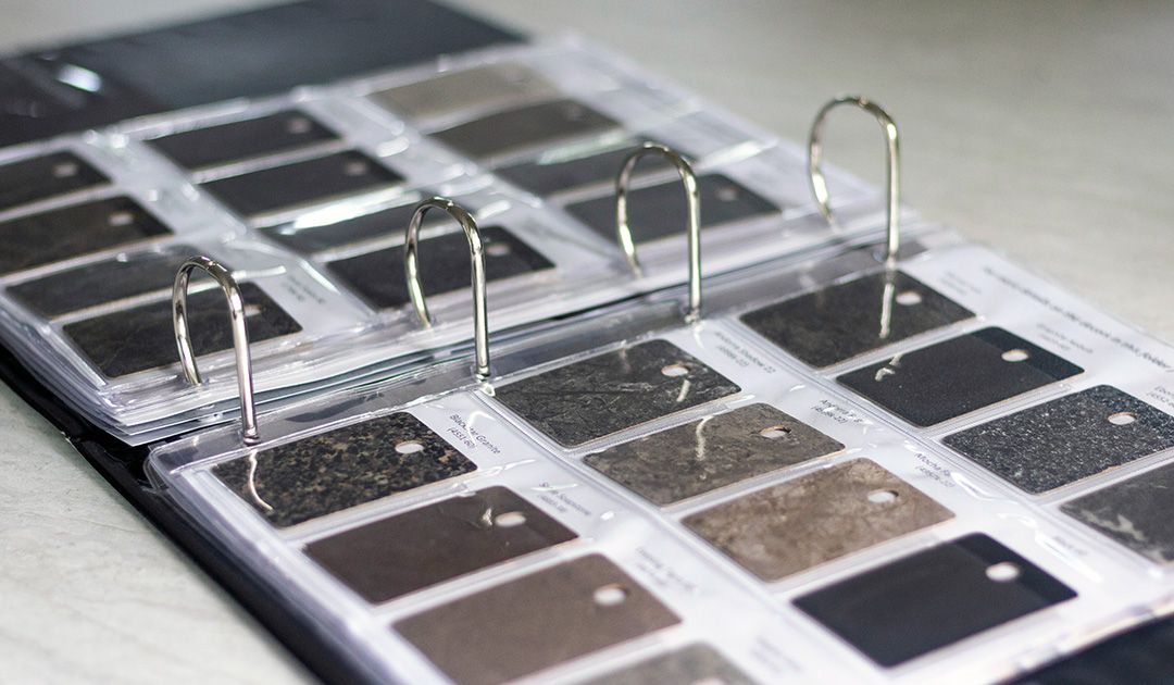 Countertop material swatches and samples contained in a binder.