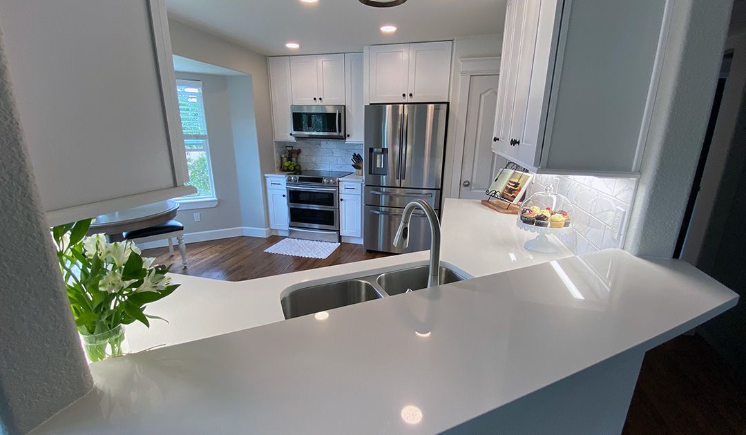Open pass-through above kitchen sink into living room. Kitchen remodel.