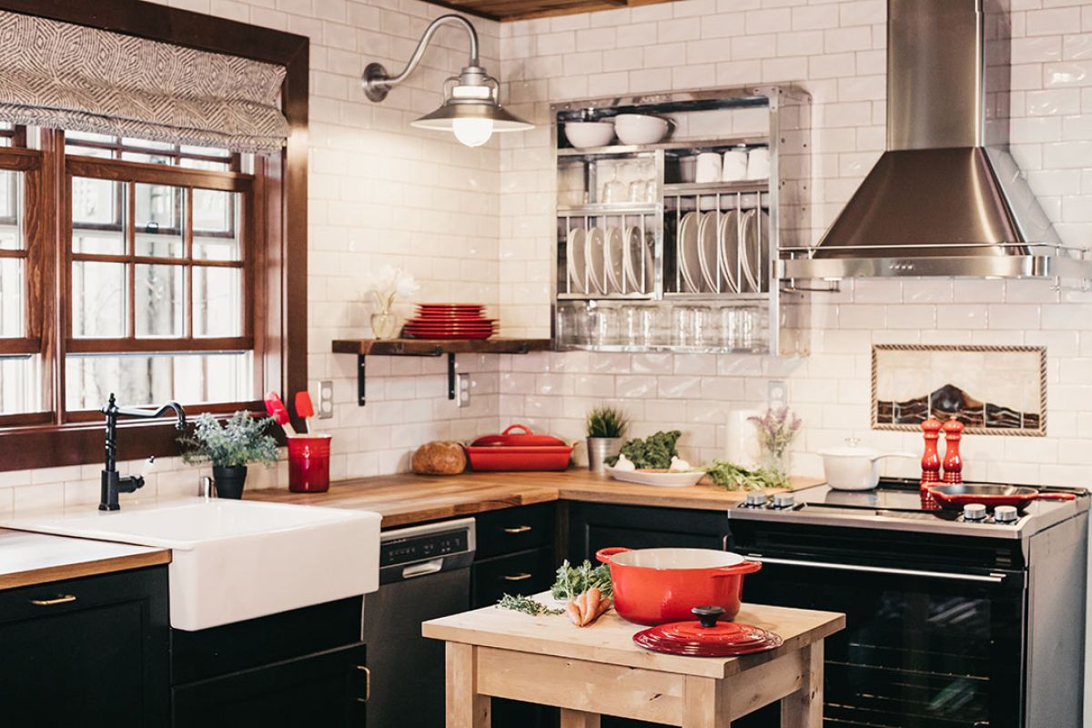 Kitchen remodeling ideas. Stove with hood, red accents, farmhouse sink.